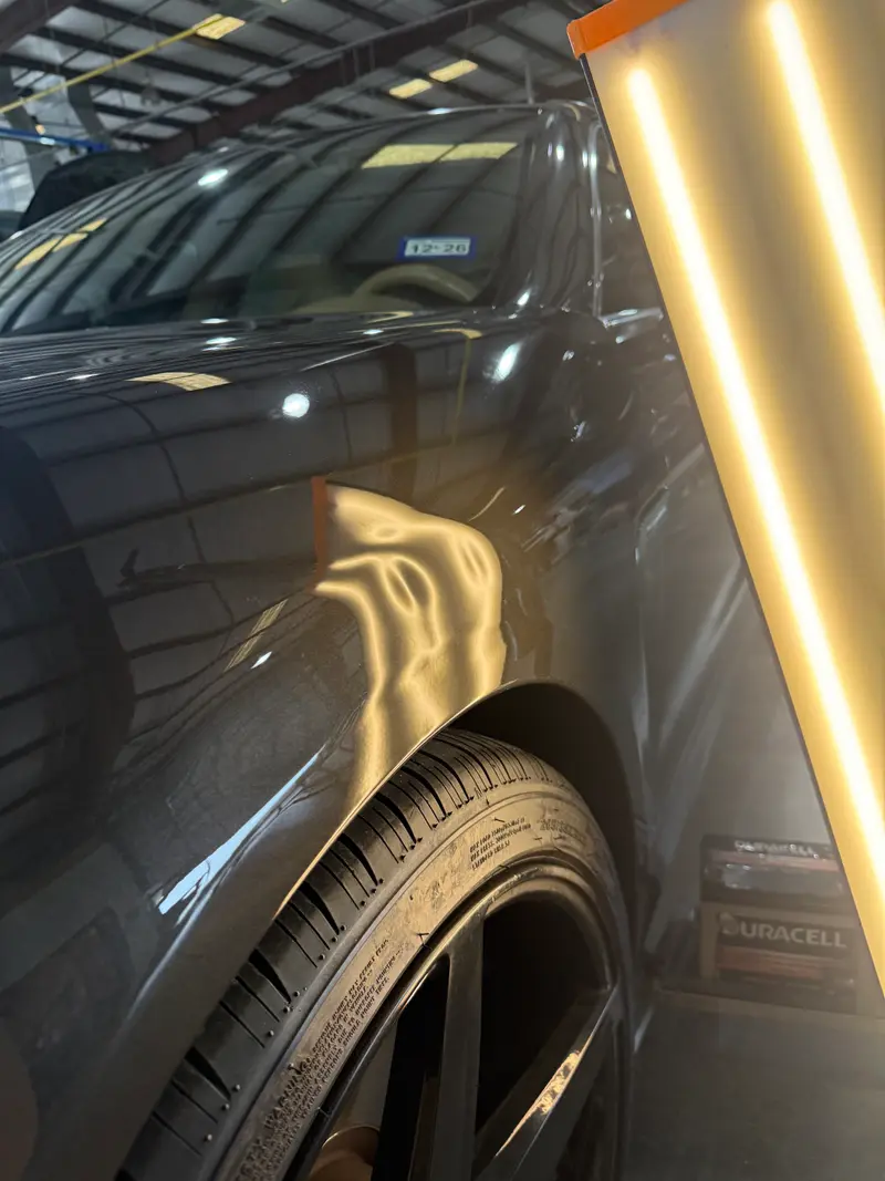 Before: Fender dent near wheel arch repaired to smooth factory finish