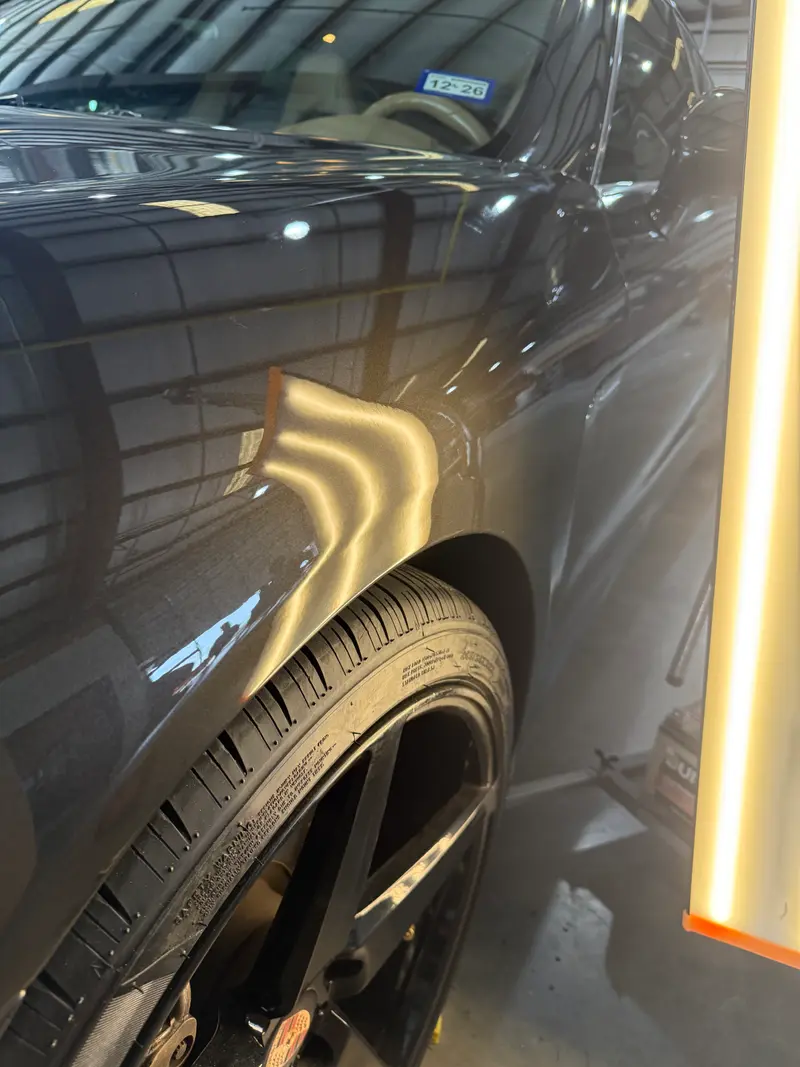 After: Fender dent near wheel arch repaired to smooth factory finish