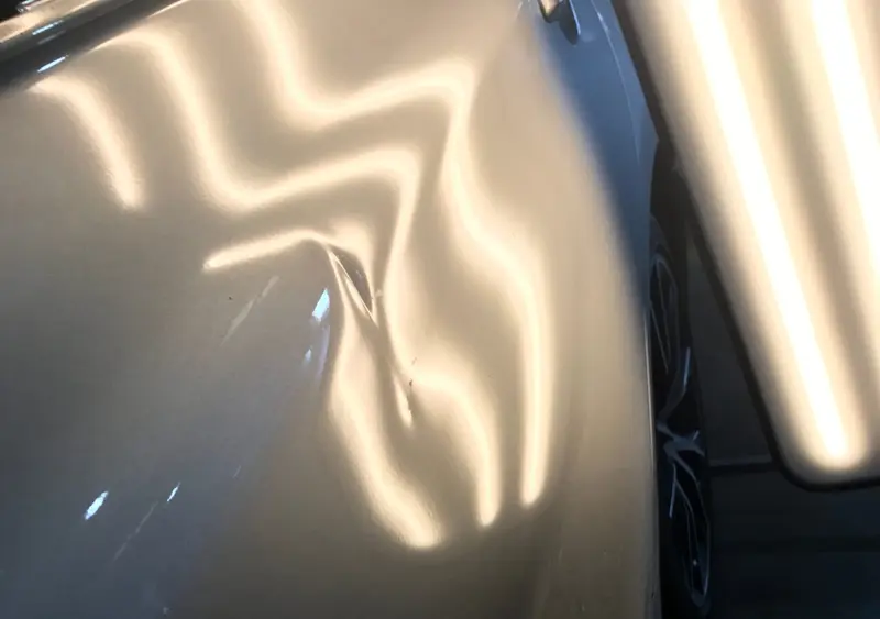 Before: Deep panel dent restored to factory condition by PdrWorks