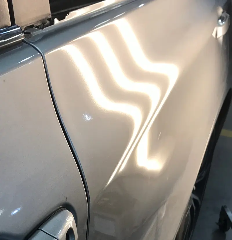 After: Deep panel dent restored to factory condition by PdrWorks