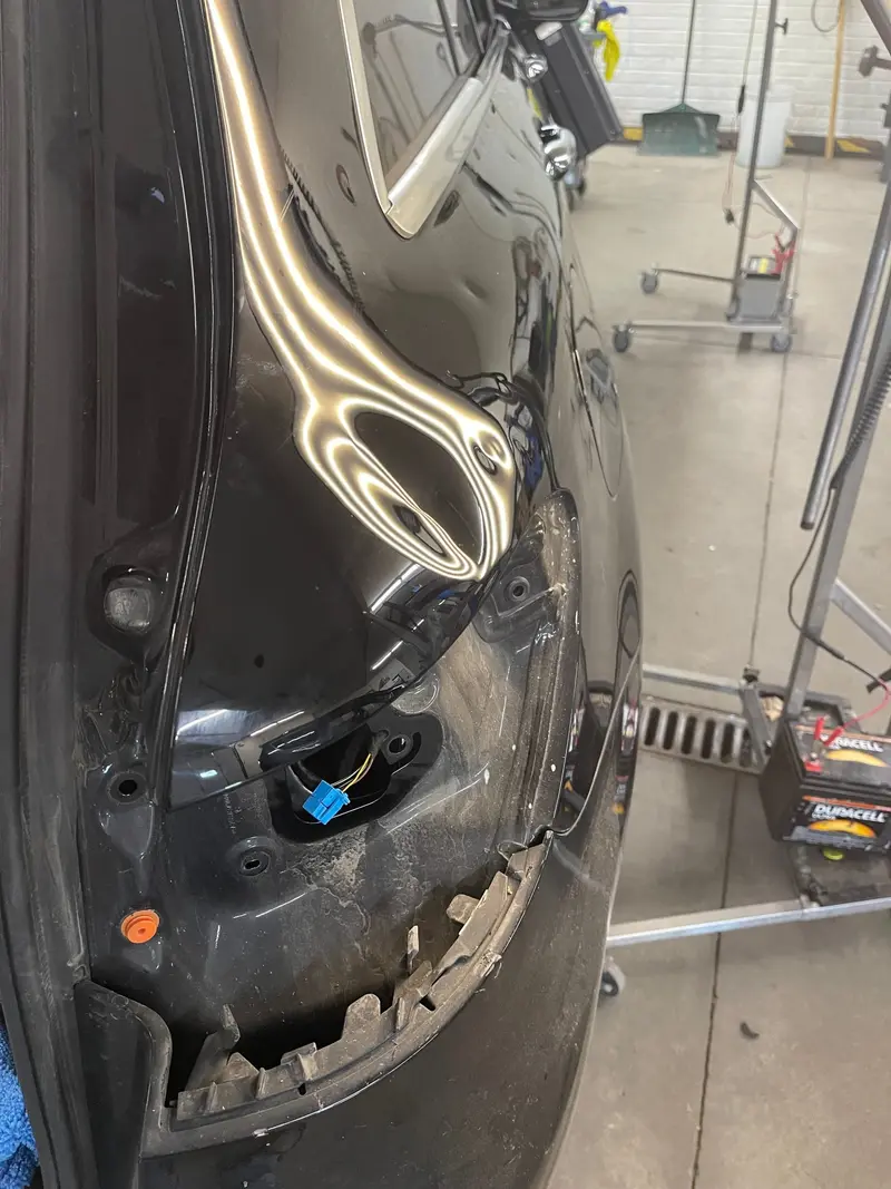 Before: Fender dent restored to smooth factory finish via paintless dent repair