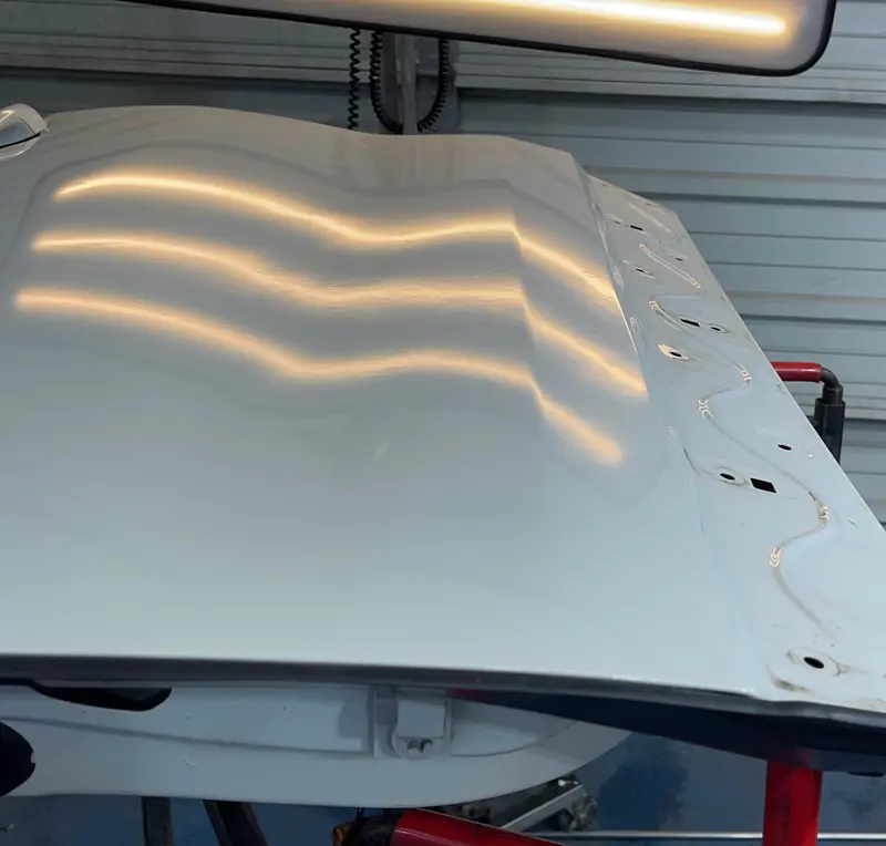 Panel restored to smooth factory finish after paintless dent repair